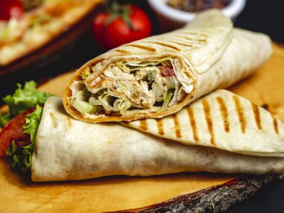 side view chicken roll grilled chicken lettuce cucumber tomato and mayo in pita side view chicken roll grilled chicken lettuce cucumber tomato and mayo in pita