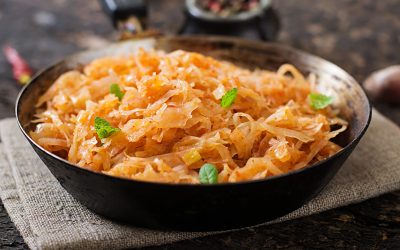 Stewed cabbage on the old wooden background in rustic style Stewed cabbage on the old wooden background in rustic style